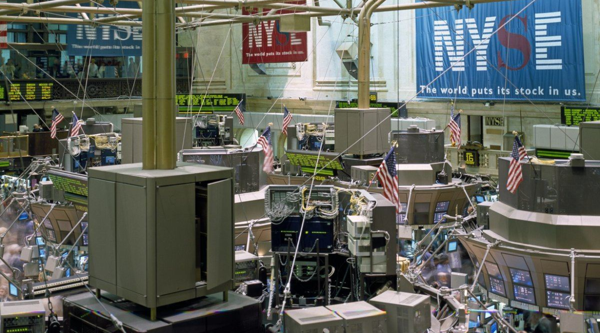 Trading floor of the New York Stock Exchange with NYSE banners and American flags