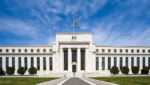 The Marriner S. Eccles Federal Reserve Board Building in Washington, D.C., under a blue sky
